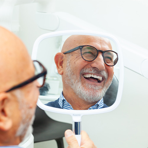Senior Man Admiring New Smile